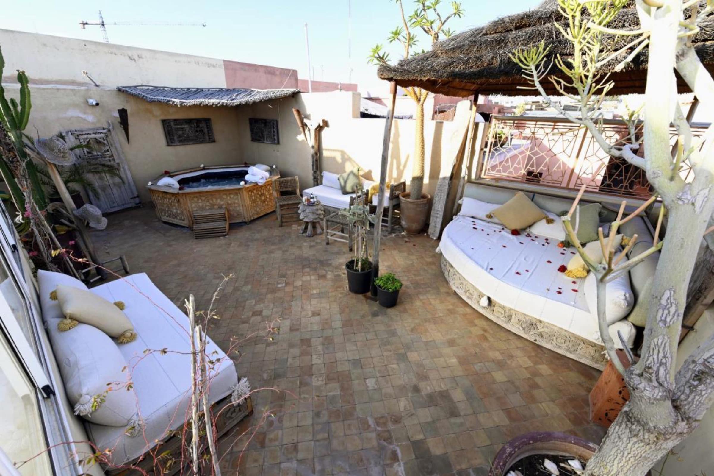 La terrasse bohème, daybeds et parasols de paille