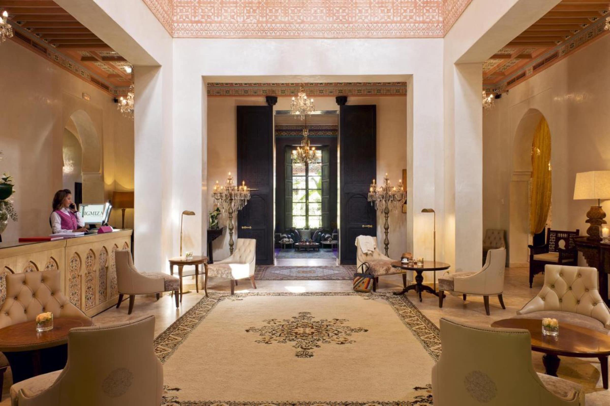 Le salon d'accueil, lustres et fauteuils sur tapis